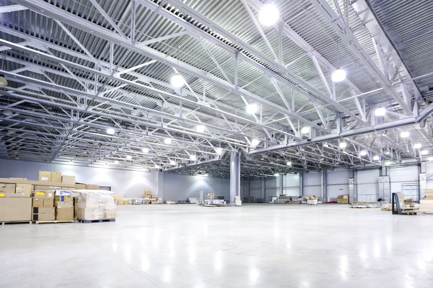 Industrial warehouse aisle illuminated by LED battens replacing the original fluorescent tube lights