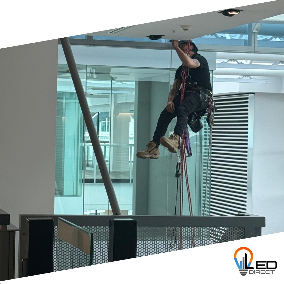 Abseil rigger installing fittings at height